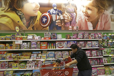 &lt;p&gt;A man pushes a child in shopping cart in the toy department at a Target store in Colma, Calif., on Thursday.&lt;/p&gt;