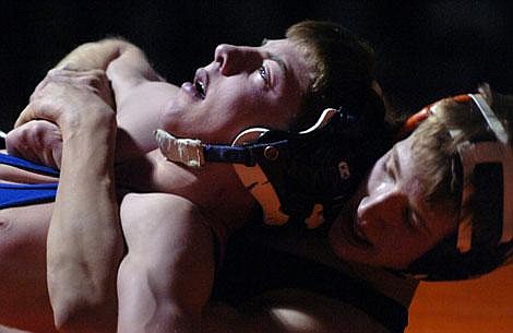 Flathead High School&#146;s Shawn Lau locks up Butte&#146;s Justin Rowling during Friday&#146;s dual at Flathead. Lau decisioned Rowling 8-0 in the 112-pound match. Garrett Cheen/Daily Inter Lake