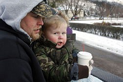 Dale Shear, left, and Jay Brugh, right, enjoy cider from the Circle during the Winterfest hay ride last Sunday afternoon.