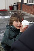 Kyle Brummitt captures the warmth of his apple cider during the hay ride at Winterfest last Sunday.