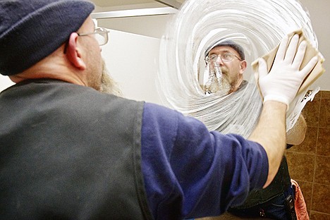 &lt;p&gt;Matt Gaier cleans a mirror inside a restroom Wednesday at the Big R Store in Coeur d'Alene.&lt;/p&gt;