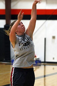 Ashley Thompson practices shooting with her left hand.