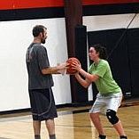 Coach Richard Griffin instructs Jessica Hansen on her free-throw technique.
