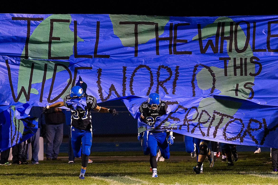 &lt;p&gt;Coeur d&#146;Alene&#146;s KC Hutchings (37) and Dylan Lockwood (28) break through a banner as the team comes onto the field for second half playoff action.&lt;/p&gt;