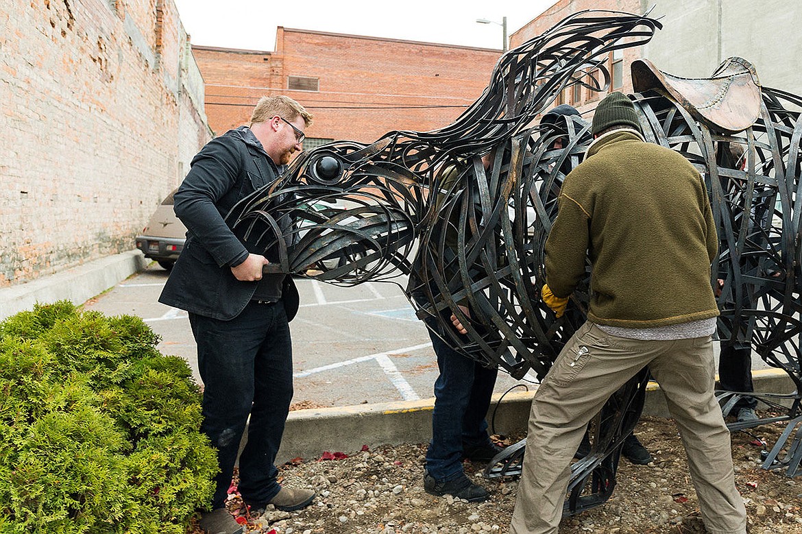 &lt;p&gt;Peter Riggs leads a team while placing a large rabbit sculpture, made by his wife artist Tyree Riggs, in its place near Art Spirit Gallery Friday in downtown Coeur d&#146;Alene. The sculpture was modeled after a pooka, a creature of Irish folklore that is believed to bring either good or bad fortune and could take the appearance of black horses, goats or rabbits.&lt;/p&gt;