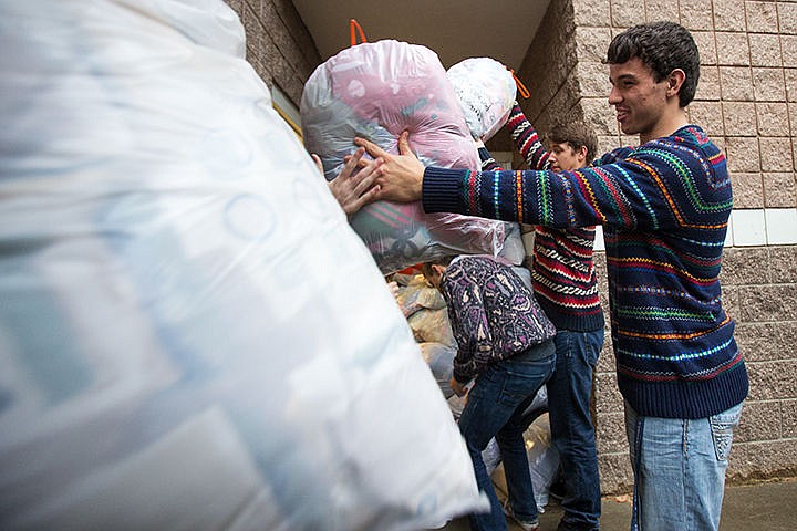 &lt;p&gt;TESS FREEMAN/Press&lt;/p&gt;&lt;p&gt;Landen Butterfield, front, and Hudson Funk pass bags of blankets to a St. Vincent de Paul van at Post Falls High School on Friday afternoon. The Post Falls Link Crew collected 465 blankets and $1,100 for the Kootenai County Humane Society and St. Vincent de Paul.&lt;/p&gt;