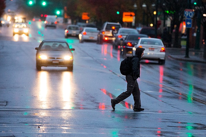 &lt;p&gt;SHAWN GUST/Press A pedestrian crosses Sherman Avenue Thursday in rainy conditions in Coeur d&#146;Alene. Showers fell most of the day and into the evening hours.&lt;/p&gt;