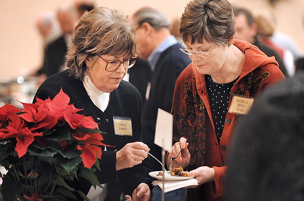 Patsy Lumpus, left, of the Flathead County Republican Women, hands a plate of chocolates to judge Michelle Reese of Whitefish at the 26th Annual Chocolate Extravaganza on Wednesday in Kalispell.