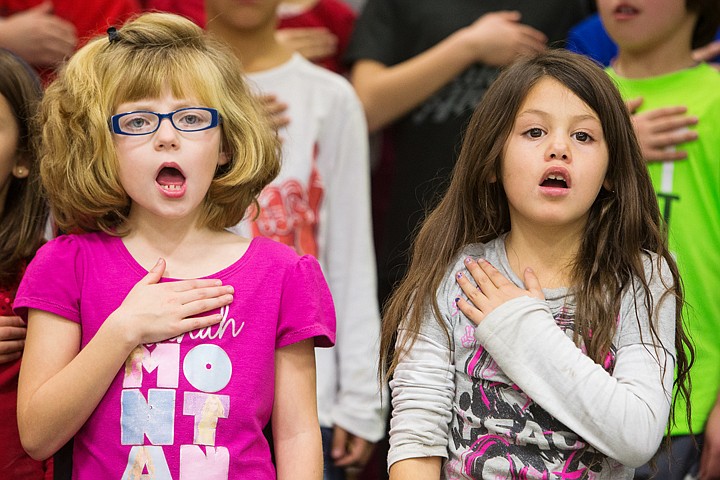 &lt;p&gt;SHAWN GUST/Press Kayla Larson, left, and Ailayah Lopez, both second grade students at Bryan Elementary, hold their hands over their hearts while singing &#147;The Star Spangled Banner&#148; during a Veterans Day assembly Wednesday at the Coeur d&#146;Alene school.&lt;/p&gt;