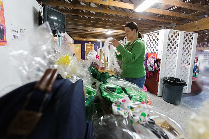 &lt;p&gt;SHAWN GUST/Press Dawn Peightal, committee member with Kid Centric Sports Association, works on auction baskets that will benefit athletes at Inland Empire Gymnastics Association. The baskets and other auction items will be available for bidding during the Quarter Auction on Saturday at the Best Western Plus Coeur d&#146;Alene Inn. Doors open at 5:30 and the event will include a spaghetti dinner and performances by gymnasts. For more information, call 772-9443.&lt;/p&gt;