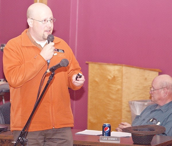 Corey Johnson of CTA Architects goes over the new two-campus design while school board member Lee Disney listens on Tuesday night.