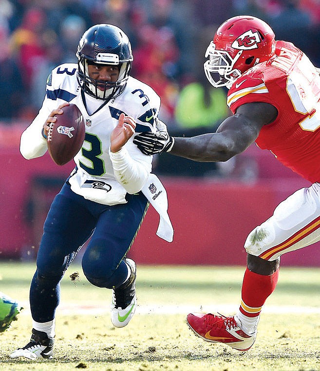 Seattle Seahawks quarterback Russell Wilson (3) avoids Kansas City Chiefs defensive end Allen Bailey (97).