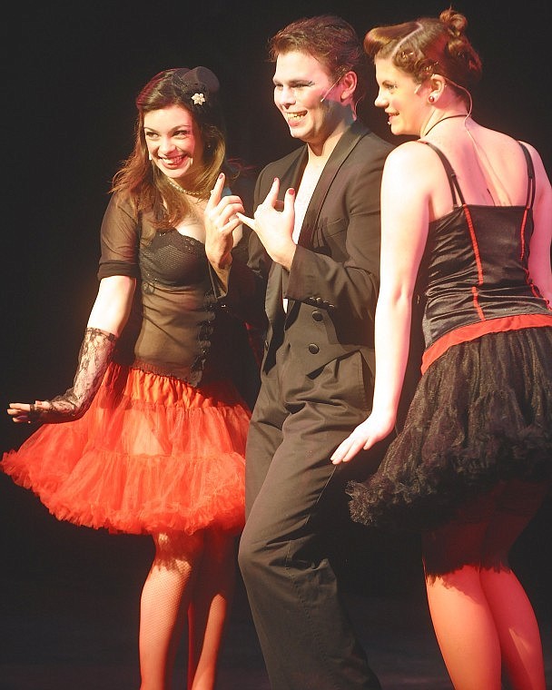 The Emcee, center, portrayed by Joshua Kelly, plays it up with Aly Root, left, and Alissa McBurney during &#147;Cabaret&#148; dress rehearsal on Monday.