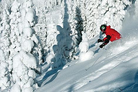 A skier makes his way down East Rim face on Big Mountain Thursday morning. Three lifts and 20 marked ski runs are open at the Whitefish resort. The snow phone reported 4 new inches, however the snow drifted much deeper in some spots. Clear skies combined with the new snow to create excellent ski conditions. Chris Jordan/Daily Inter Lake