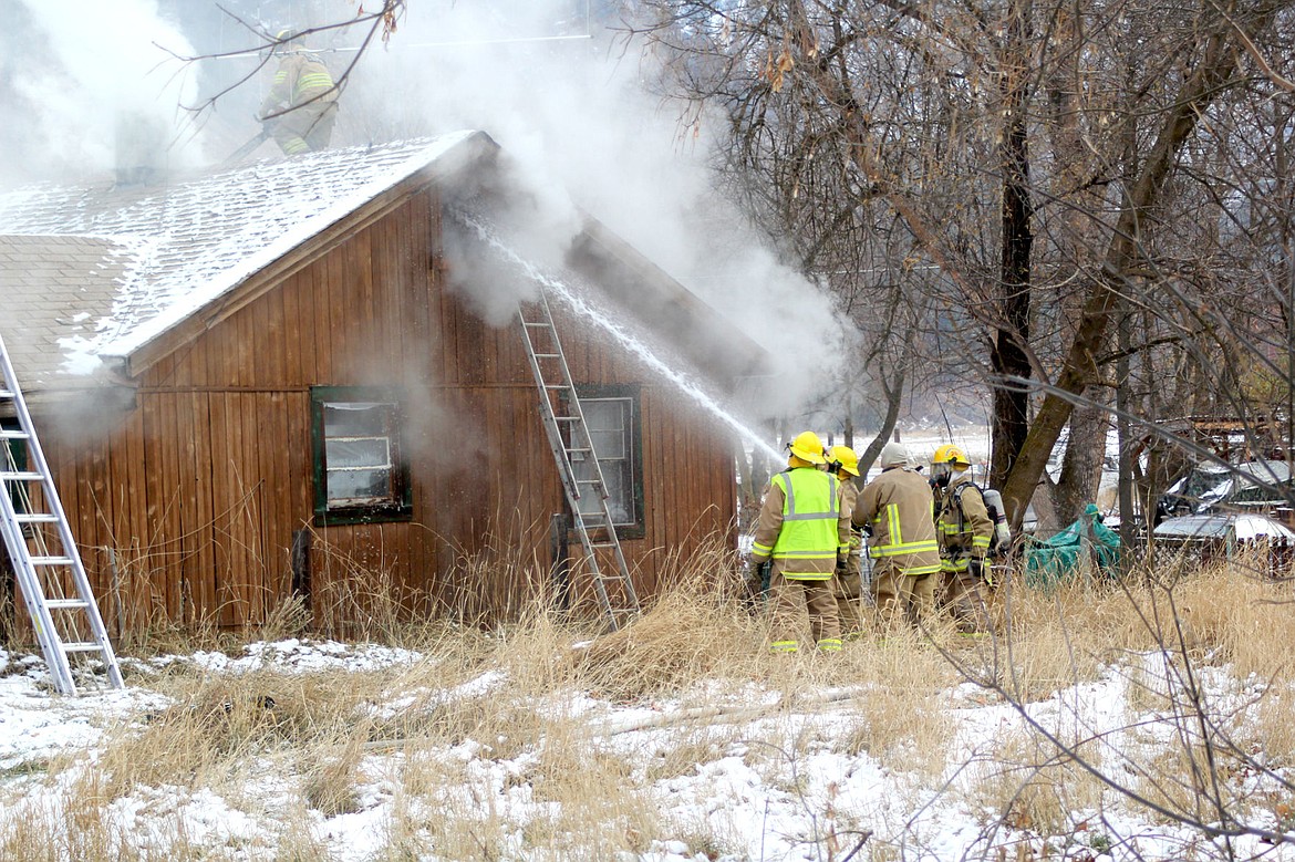 &lt;p&gt;Firefighters from the Plains-Paradise Rural Fire District blast water into a burning structure.&lt;/p&gt;