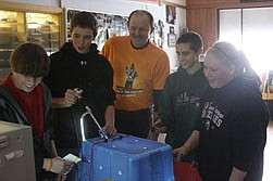 Raige Steinebach, Wyatt Winebrenner, Daniel Damschen and Keely Benson experiment with surgical tools as teacher Carl Benson observes in a presentation by Dr. Damschen.