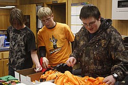 Brandon Boundy, Eric Rummel, and Chris Halling pick prizes after a drawing during the high school's college and career fair last Tuesday.