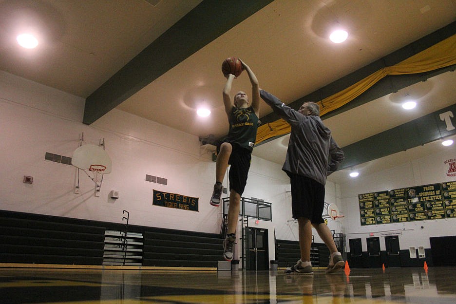 &lt;p&gt;Courtney Cheesman of the St. Regis Lady Tigers goes up for a layup as her coach attempts to block the shot during practice last week.&lt;/p&gt;