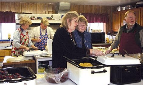 Heather Hasty/Valley Press Lores Porter and Thori and John Hodge serve dinner while Sherry Johnson and Phil Seng prepare more food.