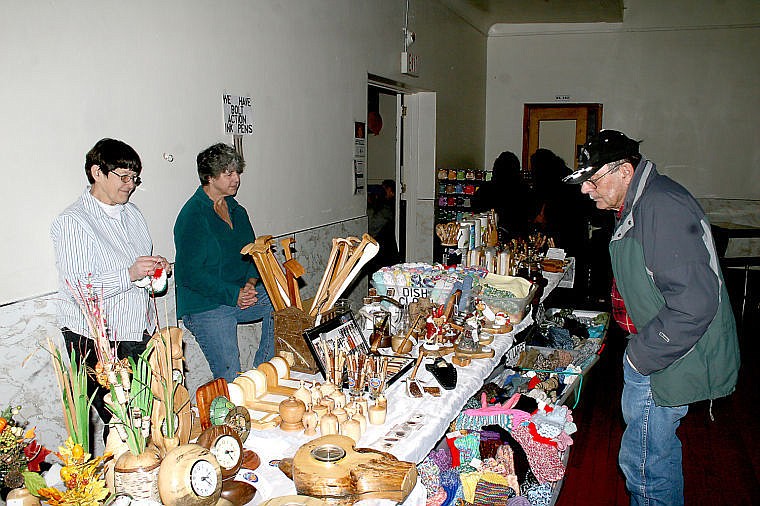 &lt;p&gt;Ruth Johnson and Sue Braatten stand by as Jerry Dalton looks over the selection of handmade woodcarvings for sale.&lt;/p&gt;