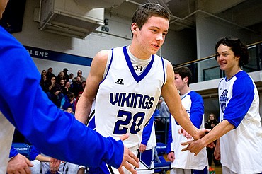 <p>Coeur d'Alene's Sam Matheson jogs onto the court as he is introduced as part of the starting line-up during a match-up against Shadle Park on Thursday at Coeur d'Alene High School. The Vikings defeated the Highlanders 45-44.</p>