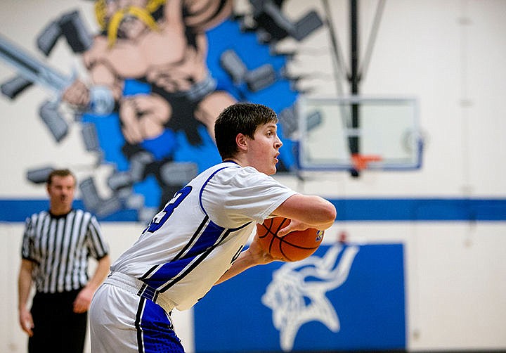 &lt;p&gt;Coeur d'Alene's Will McElver scans the court for an open teammate to pass to during a match-up against Shadle Park on Thursday at Coeur d'Alene High School. The Vikings defeated the Highlanders 45-44.&lt;/p&gt;