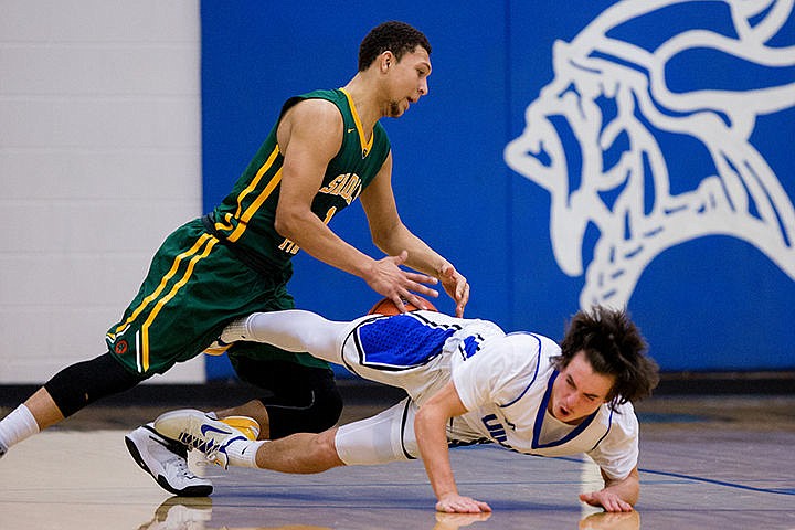 &lt;p&gt;Coeur d'Alene's Brody Lundblad falls to the court with Shadle Park's Andreas Brown on Thursday at Coeur d'Alene High School. The Vikings defeated the Highlanders 45-44.&lt;/p&gt;