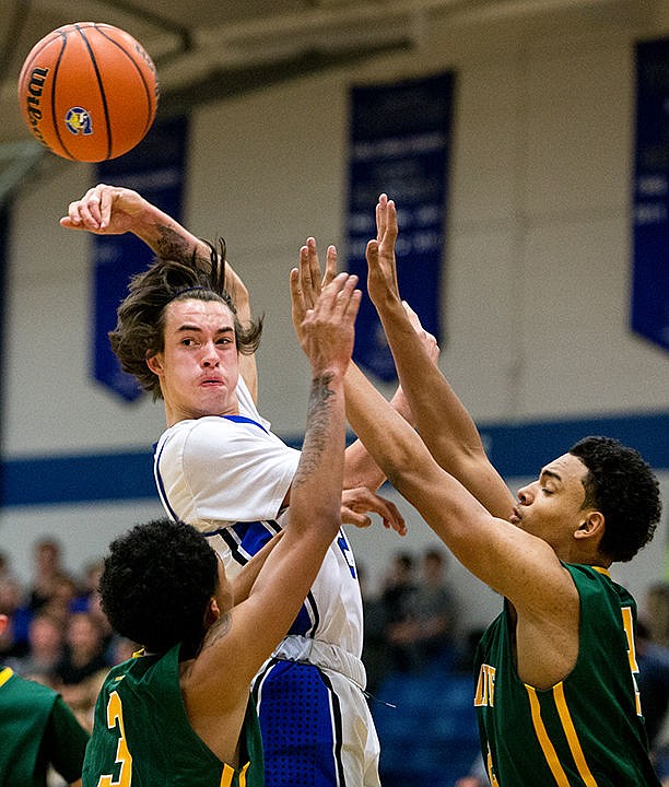 &lt;p&gt;Coeur d'Alene's Brody Lundblad gets a pass off as Shadle Park's Markieth Brown (3) and Kobe Reese attempt to block it on Thursday at Coeur d'Alene High School.&lt;/p&gt;