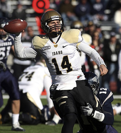 &lt;p&gt;Idaho quarterback Brian Reader (14) throws under pressure from Nevada's Kaelin Burnett (12) during the first quarter Saturday at Reno, Nev.&lt;/p&gt;