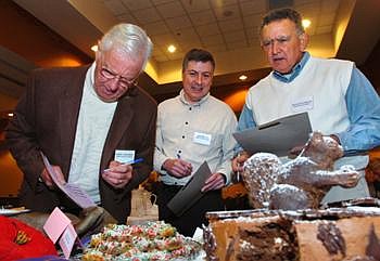 Chocolate judges, from left, Harry Solomon, Andy Tegoli and Frank Taverrite peruse the amateur entries for Best of Show at the 24th annual Chocolate Extravaganza on Wednesday morning at the Hilton Garden Inn in Kalispell. The event is a fundraiser for Flathead County Republican Women. Jennifer DeMonte/Daily Inter Lake