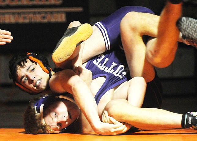 &lt;p&gt;Flathead's Payton Hume puts Butte's Kaleb Ferriter in a cradle during a 15-4 major decision in the 145-pound match at Flathead on Friday. The Braves won the dual 35-31. (Aaric Bryan/Daily Inter Lake)&lt;/p&gt;