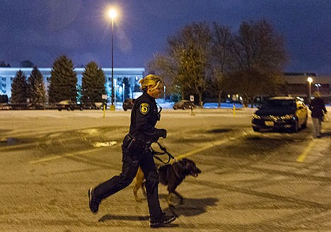 &lt;p&gt;After receiving another call, Coeur d&#146;Alene Police officer Amy Winstead runs through the Shopko parking lot with Kane, the department&#146;s apprehension dog.&lt;/p&gt;