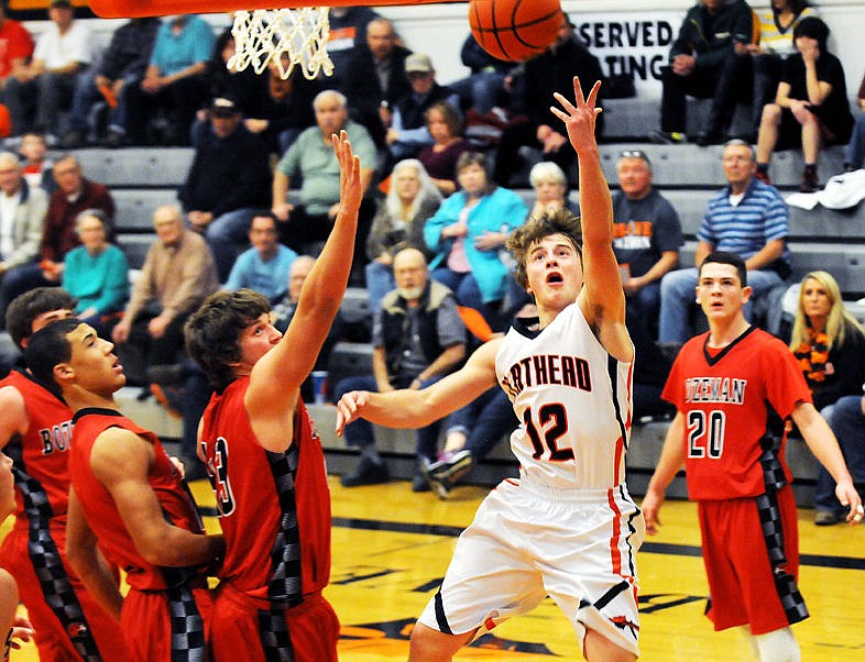 &lt;p&gt;Flathead's Kye AuClaire drives past a group of Bozeman defenders for a basket during the first quarter at Flathead on Saturday. (Aaric Bryan/Daily Inter Lake)&lt;/p&gt;