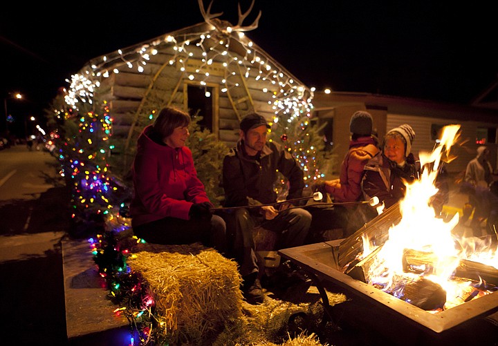 &lt;p&gt;From left, Jessica Muir, Dan Muir, Christiane Hinterman and
Cindy Woods roast marshmallows on the U.S. Forest Service float at
the Night of Lights parade Friday night in Columbia Falls.&lt;/p&gt;