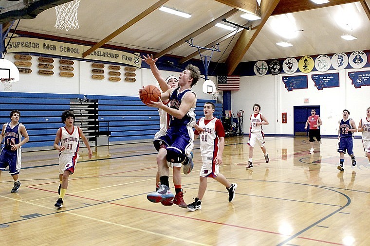 <p>Superior senior Adam Kay elevates on a fast-break attempt during a scrimmage between the varsity and junior varsity squads on Saturday. The Bobcats start their season on the road this Friday.</p>
