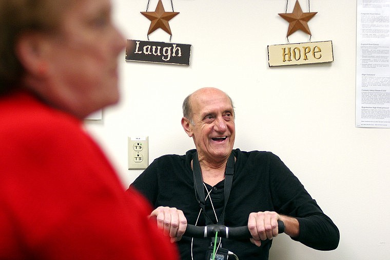 Bud Heyne works out on a rowing machine while making conversation with respiratory therapist Robert O&#146;Rouke (not pictured) during a pulmonary rehabilitation session last week at St. John&#146;s Lutheran Hospital in Libby. There are 2,800 patients receiving care for asbestos-related diseases.