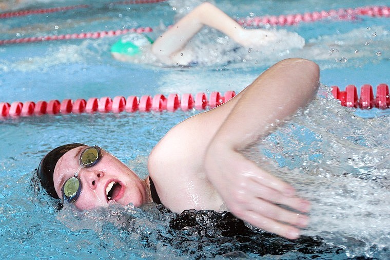 Flathead's Lisa Schueltert and Glacier's Sara Burch (top) swim in the 100 freestyle during Saturday's invitational meet at The Summit.