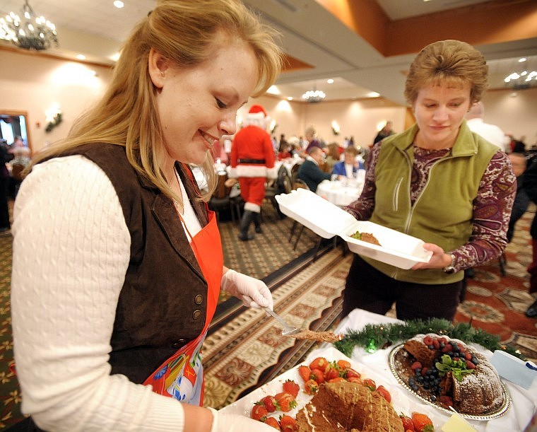 Kalispell Mayor-elect Tammy Fisher, left, serves chocolate to Ardis Larsen of Lakeside on Wednesday at the 25th Anniversary Chocolate Extravaganza. More than 500 people attended this year&#146;s event.