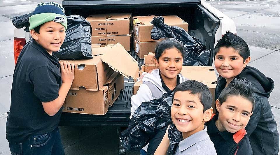 From left, Rodnie Gonzalez, Diego Perez, Salvador Velasco, Michelle Miranda and Aiden Lopez unload donated turkeys.