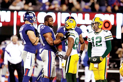 &lt;p&gt;New York Giants defensive end Justin Tuck (without helmet) talks with Green Bay Packers' Jermichael Finley (88) as Aaron Rodgers (12) looks on during a time out in their game Sunday in East Rutherford, N.J.&lt;/p&gt;