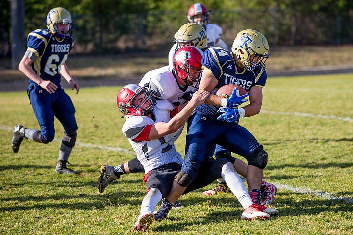 &lt;p&gt;Timberlake running back Caleb Munson (44) is brought down by Tyler Visser, bottom, and Elliot Whiting of Gooding on Saturday, Nov. 5, 2016 at Timberlake High School.&lt;/p&gt;