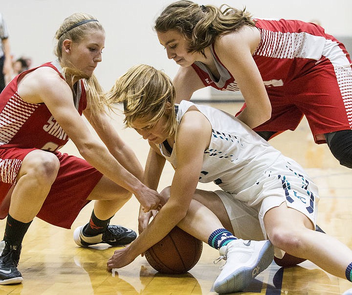 &lt;p&gt;LOREN BENOIT/Press Sandpoint defenders Taylor Ward, left, and Trinity Golder try to pry the loose ball away from Lake City forward Bridget Rieken during a game on Thursday, Nov. 17, 2016 at Lake City High School.&lt;/p&gt;