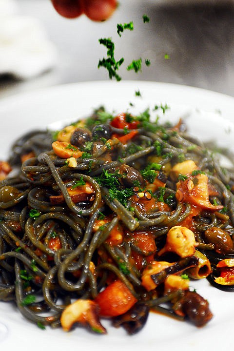 &lt;p&gt;Fabrizio Moroldo adds a dash of parsley to a plate of spaghetti with cuttlefish black ink on Monday, December 1, at Moroldo's in Bigfork. The dish features octopus, fresh tomatoes, tomato sauce, basil, garlic and olives from Italy. There is no cheese in this dish to protect the unique flavor of the black ink noodles. (Brenda Ahearn/Daily Inter Lake)&lt;/p&gt;