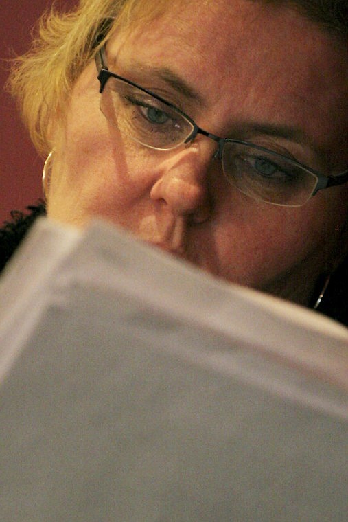 Suzy Rios looks through a printout of a PowerPoint presentation put together by EPA toxicologist David Berry.