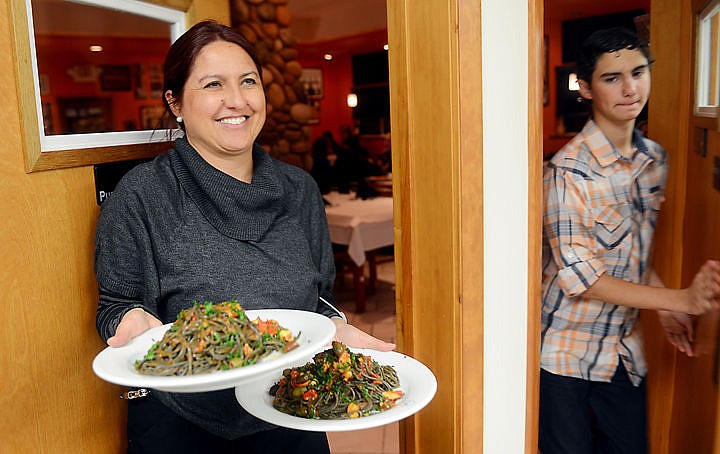 &lt;p&gt;Laura Moroldo, co-owner of the restaurant and her son Ethan, 15, simultaneously enter and exit the kitchen as things speed up at Moroldo's on Monday, December 1, in Bigfork. (Brenda Ahearn/Daily Inter Lake)&lt;/p&gt;