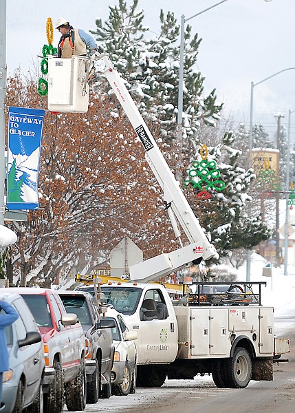 Terry Wharton of Kalispell put up the new Christmas lights along Nucleus Avenue in Columbia Falls on Tuesday morning. Fifty new lights; 24 trees for Nucleus, and 26 stars for Highway 2, were purchased by the community for just under twenty thousand dollars. They are replacing lights that were originally purchased 40 years ago.