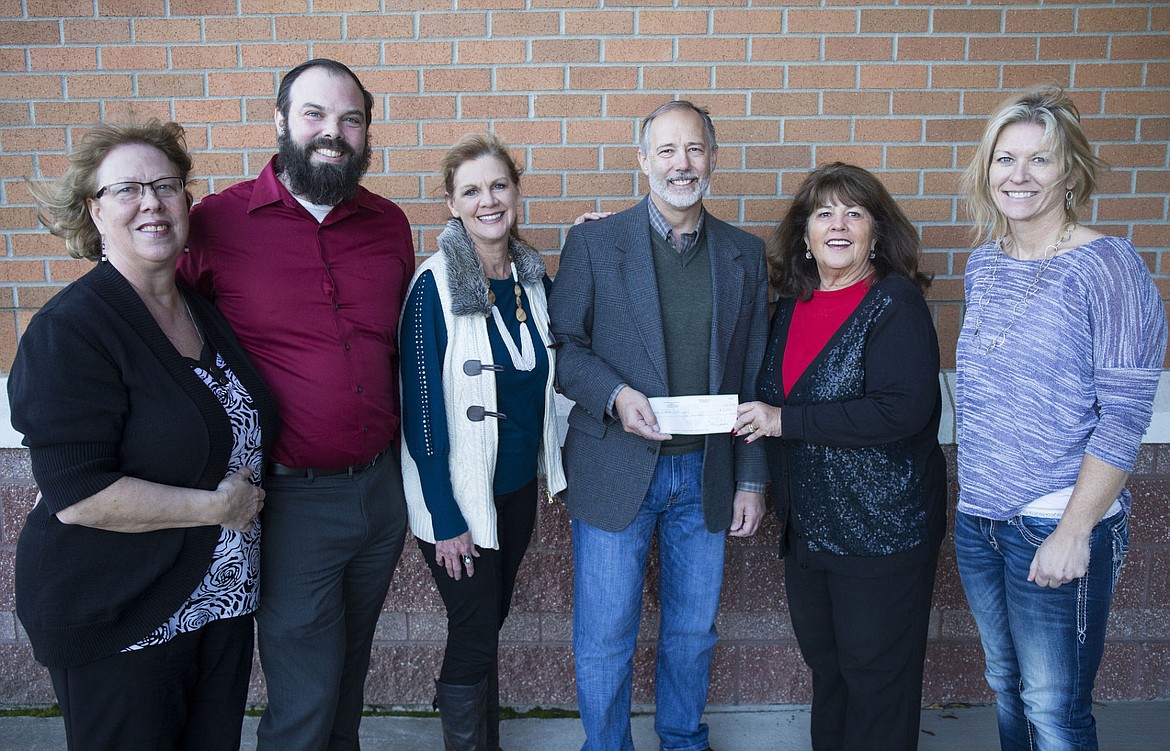 <p>The North Idaho Housing Coalition Board presents Idaho Youth Ranch with a $5,000 donation on Tuesday at Post Falls City Hall. From left, Gretchen Mark with NIHC, Kevin Vedder with Wells Fargo, NIHC Executive Director Lori Isenberg, Greg Orlando with Idaho Youth Ranch, NIHC President Kerri Thoreson and Vicki Isakson with Idaho Department of Labor. Safe Passages, Family Promise of North Idaho and UGM all individually received $5,000 as well from NIHC.</p>