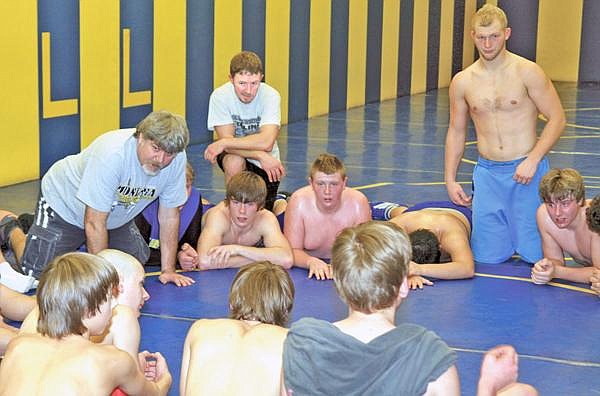 Brad Fuqua/The Western News Libby High School first-year head coach Todd Schatz gets down on the mat with his wrestlers during practice last week. Schatz succeeds Jay Graham as head coach after serving as an assistant for 20 years.