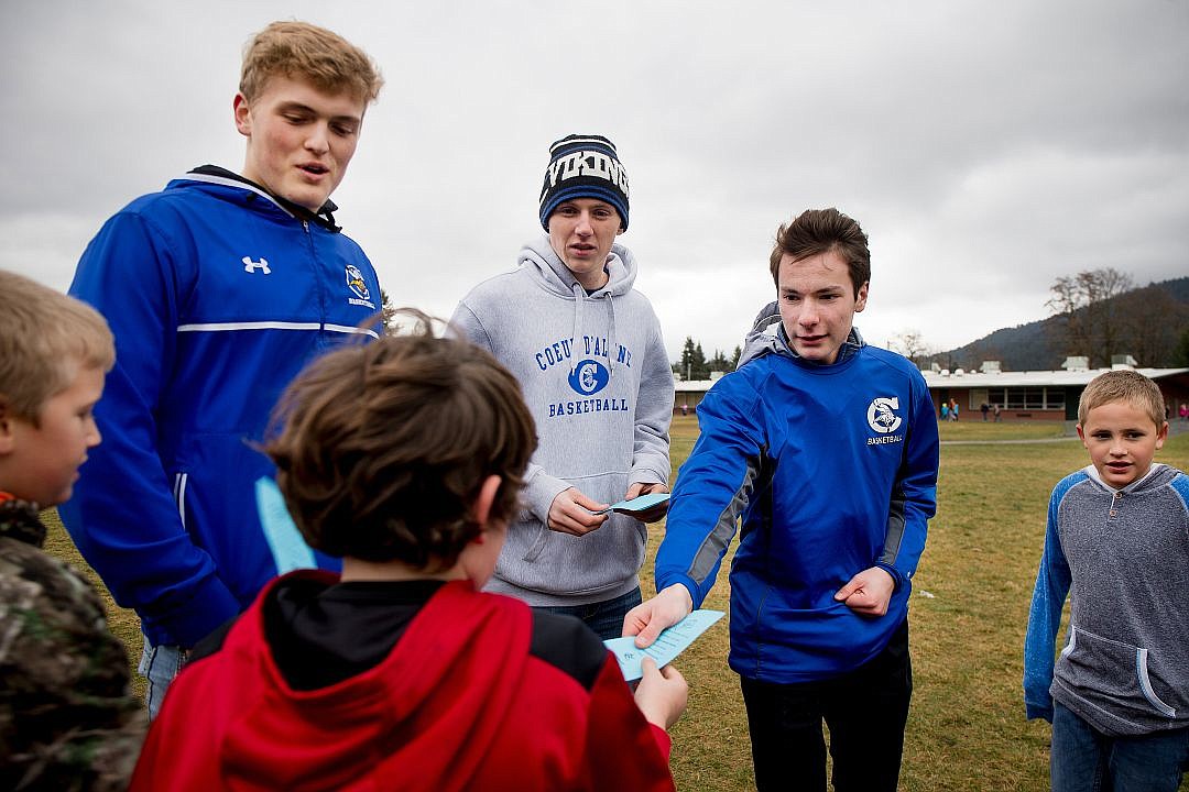 &lt;p&gt;From left to right, Coeur d'Alene High School basketball players Joey Naccarato, Bryce Bronson and Justin Kofmehl hand out free tickets to Saturday's home game against Eastmont to Dalton Elementary School students during recess on Friday.&lt;/p&gt;