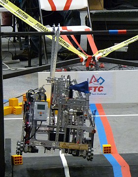 SD30 Robotics' robot hangs from the pull-up bar on the course